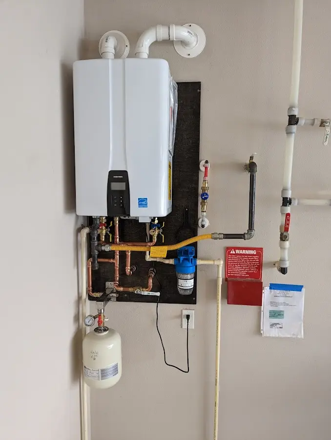 Professional plumber installing copper piping in a Obetz home